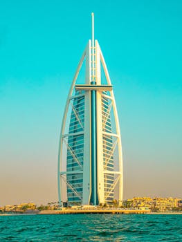 Stunning view of the Burj Al Arab in Dubai during golden hour, capturing the vibrant skyline and ocean.
