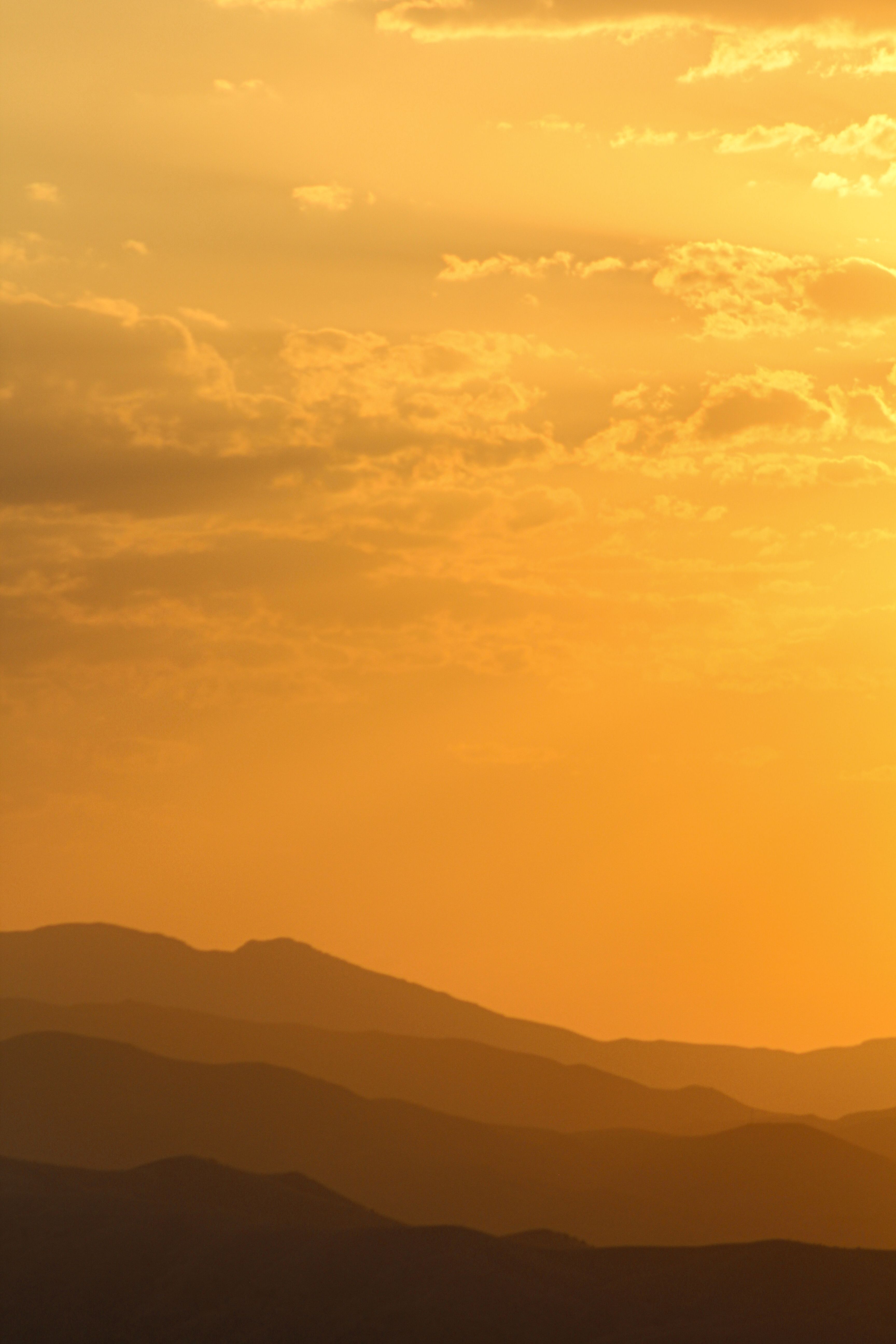 Yellow Sky over Hills Silhouette at Sunset · Free Stock Photo