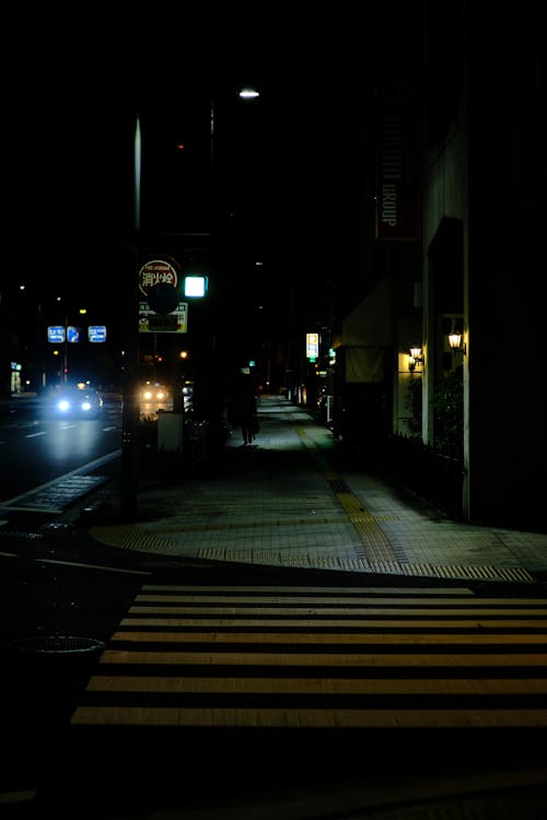 Crosswalk and Sidewalk in Town at Night