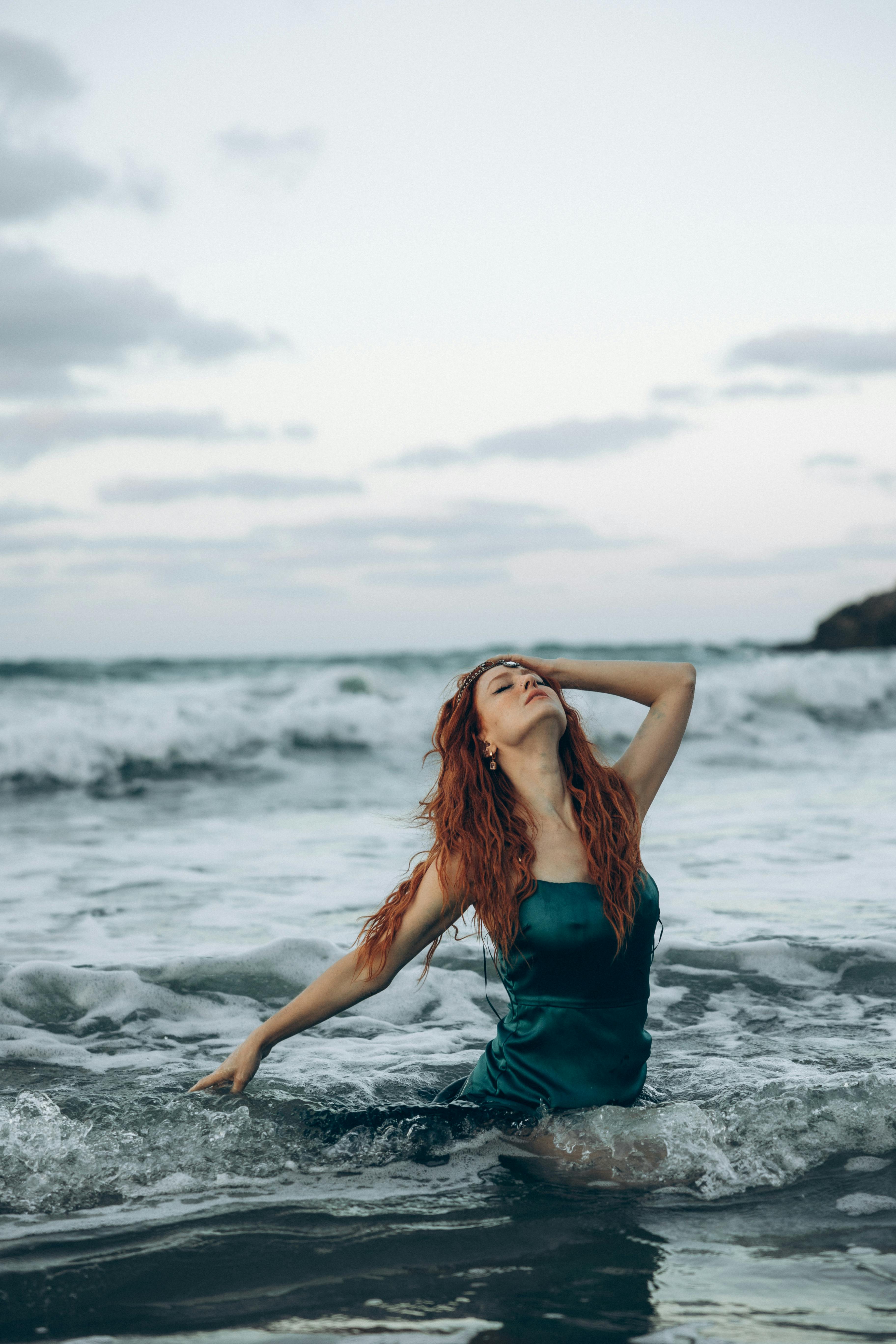 a woman with red hair in the ocean