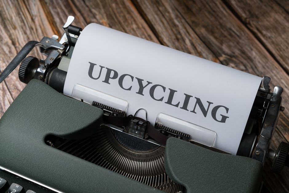 Close-up of a vintage typewriter showing a sheet with 'Upcycling' on it, promoting sustainability.