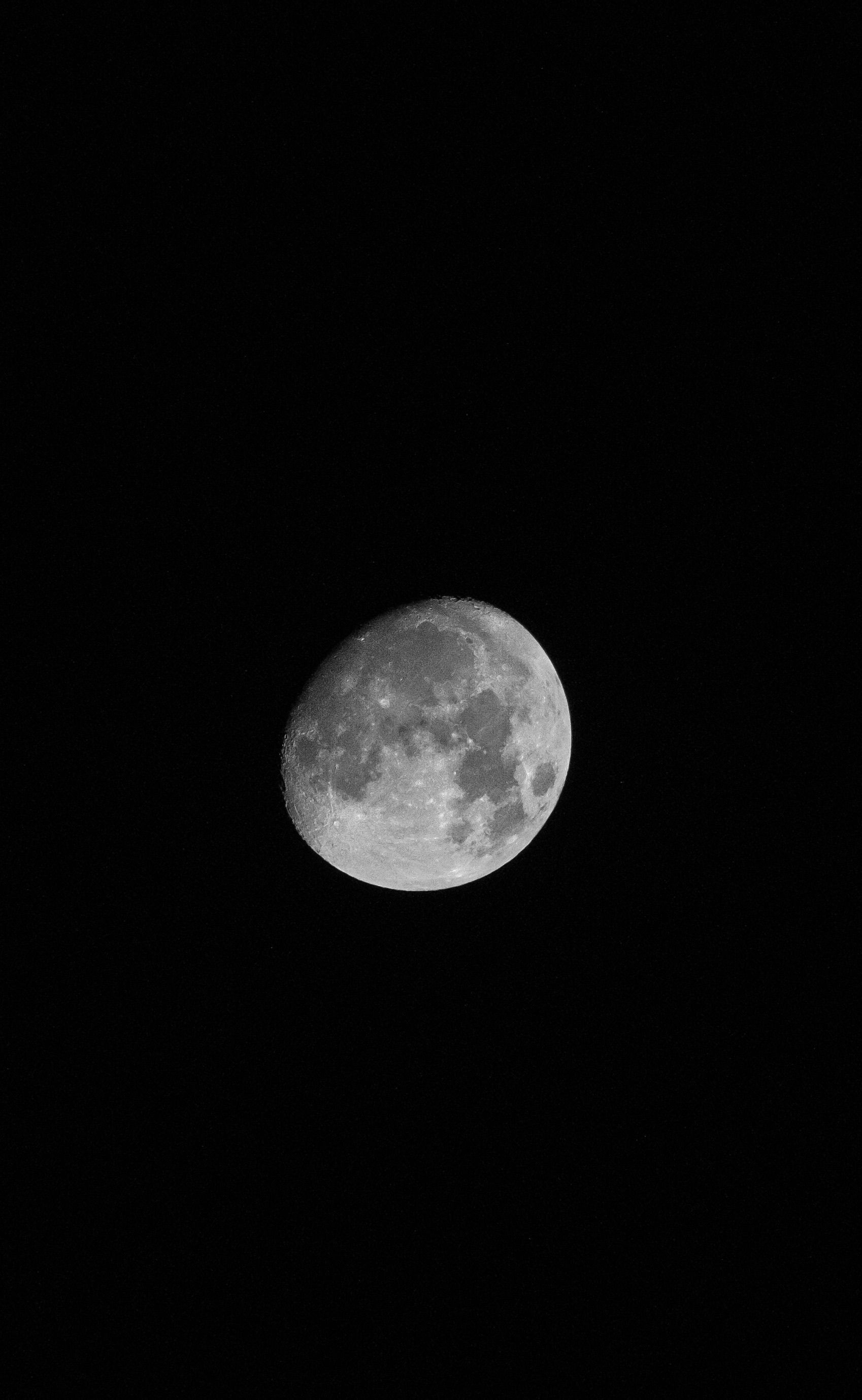 Black and white image of the moon capturing its craters and textures.