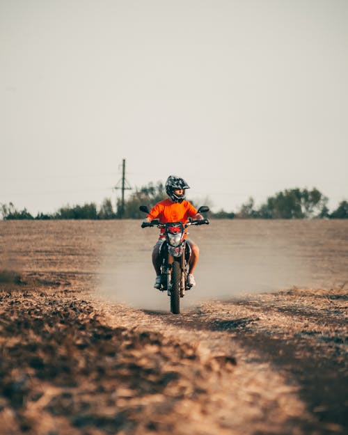 A person riding a dirt bike on a dirt road