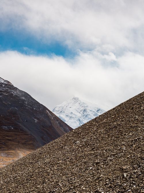 Free Breathtaking view of snow-capped mountains against blue skies in Nepal's rugged landscape. Stock Photo