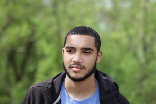 Portrait of a Man with a Beard Standing Outside 