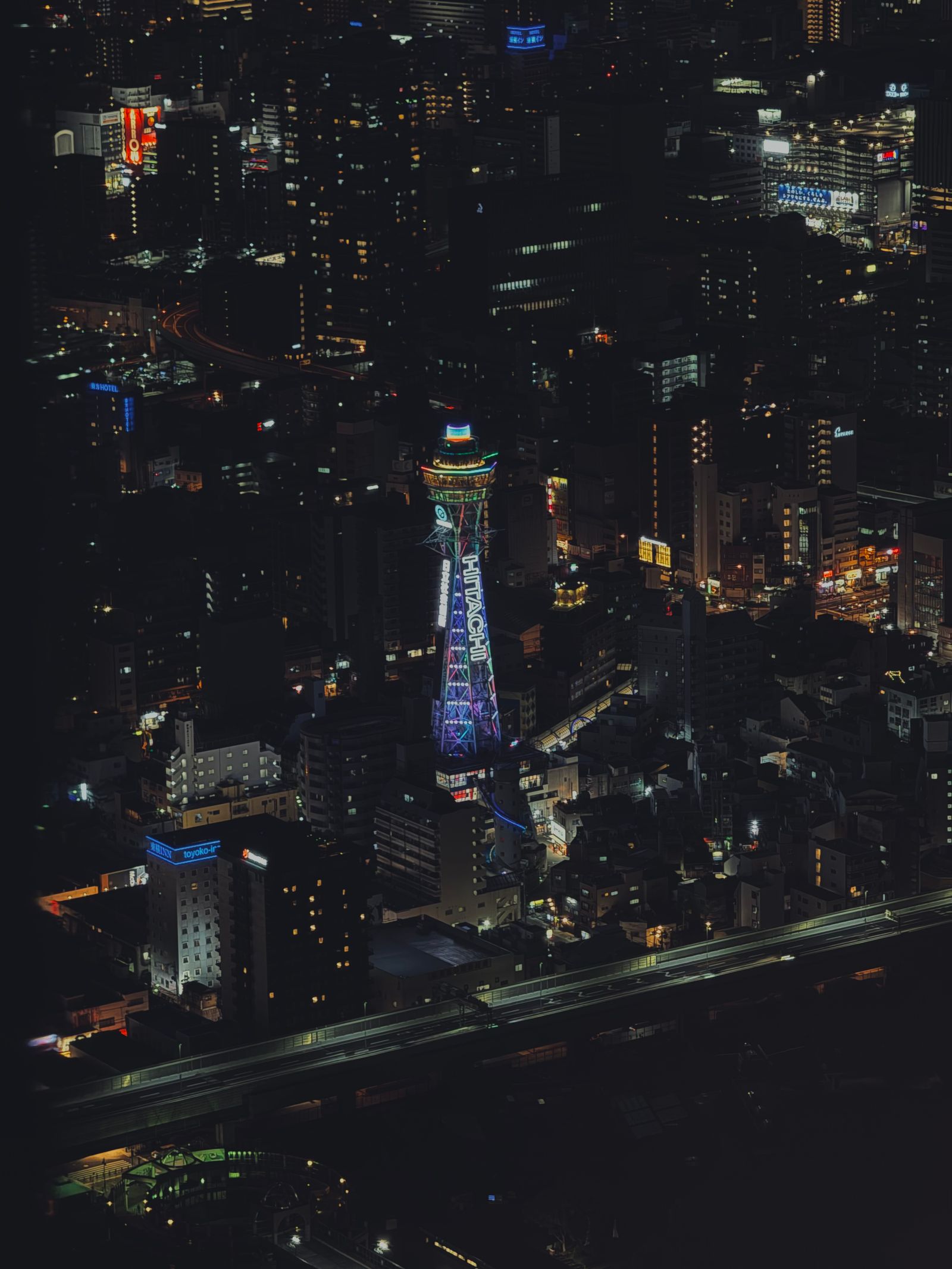 Osaka skyline at night from above with light trails