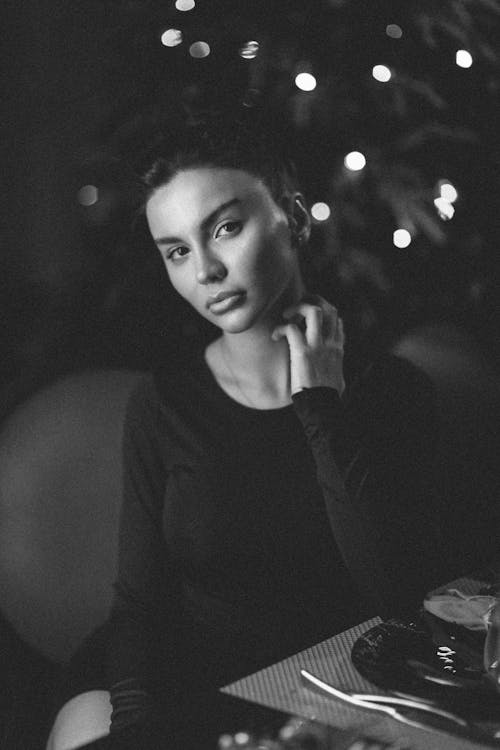 Black and white portrait of a woman sitting at a table