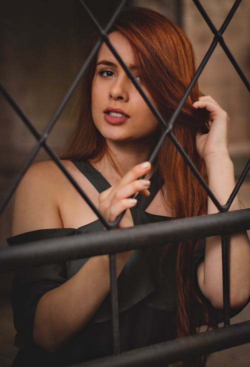 Woman in Standing in Front of Fence