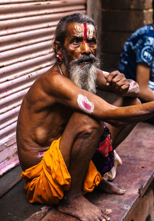 Devotee of Shiva Crouching on a City Street
