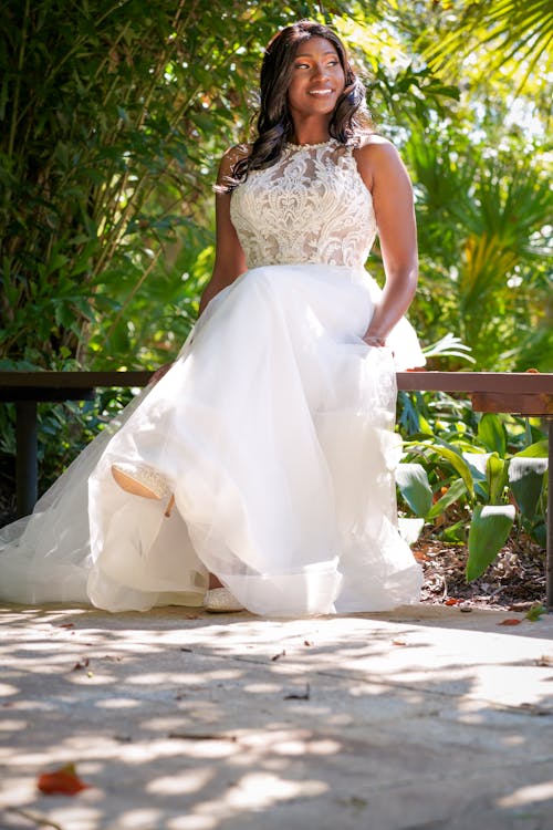 A bride sitting on a bench in the garden