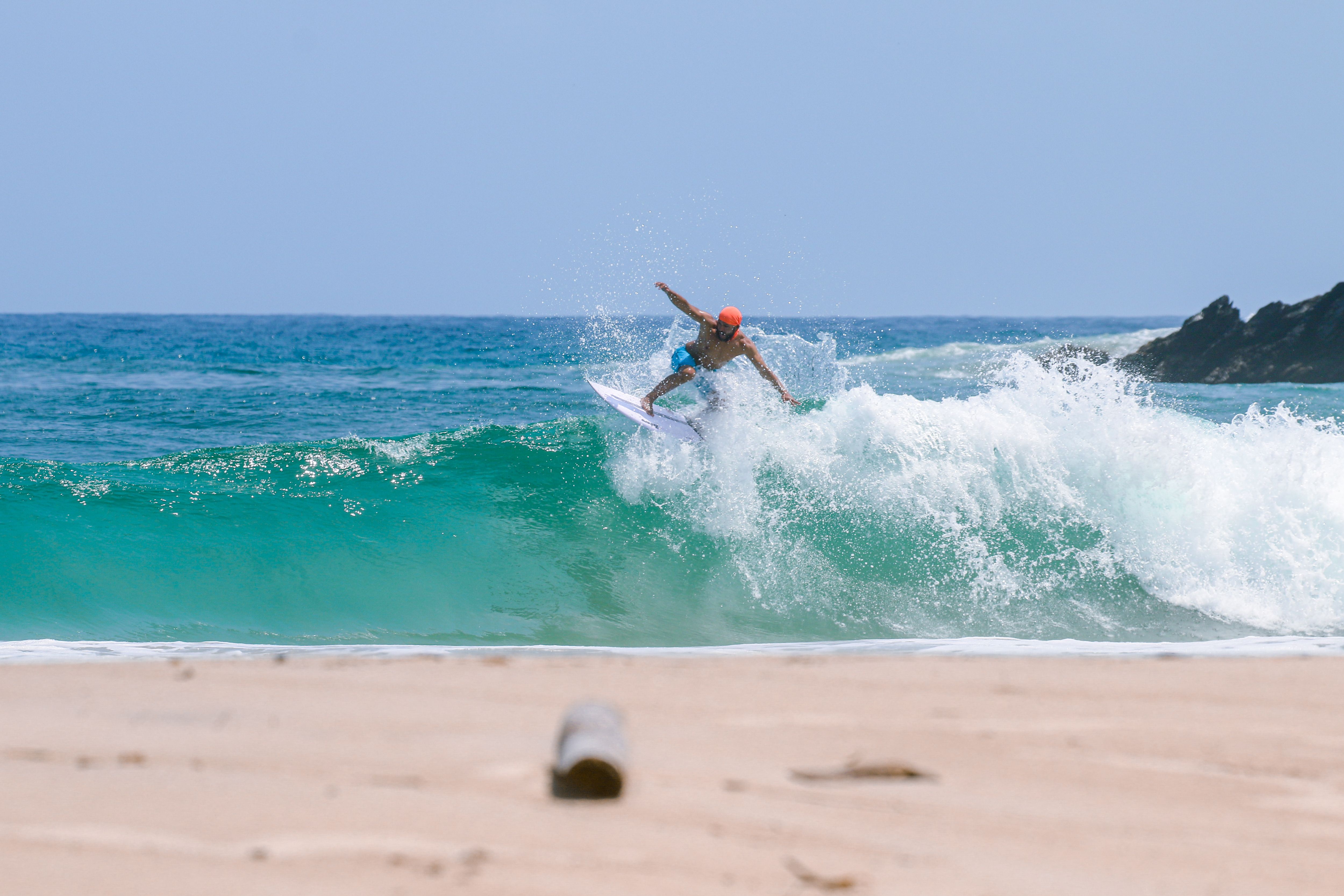 A person riding a surfboard on top of a wave · Free Stock Photo
