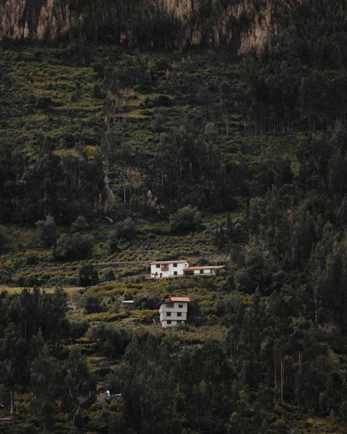 Free Aerial view of rural Cusco, Peru, with houses nestled in lush greenery and forested hills. Stock Photo