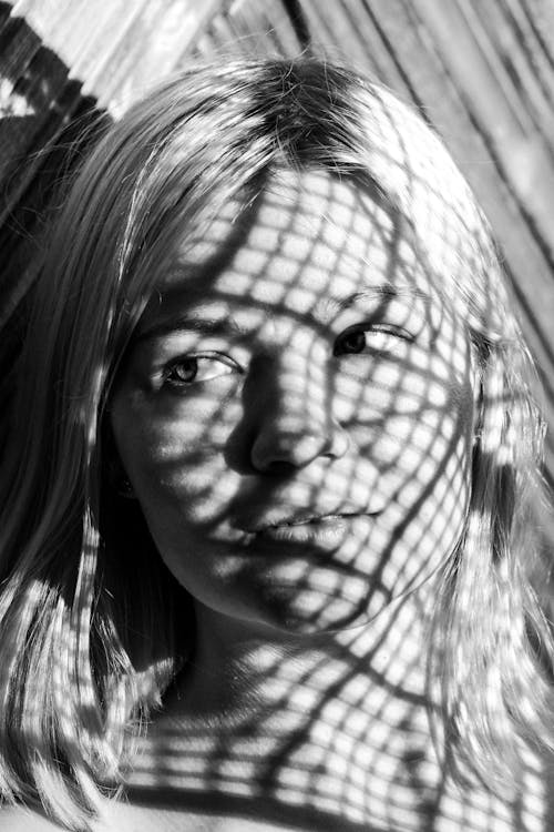 Black and White Head Shot of Person with Shadows Obscuring Face 