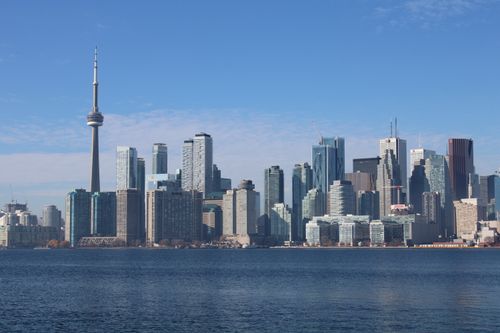 Free Capture of Toronto's bustling skyline with the iconic CN Tower on a clear day. Stock Photo
