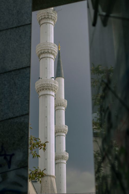 Free Tall white minarets reflect in modern architecture on a cloudy day. Stock Photo