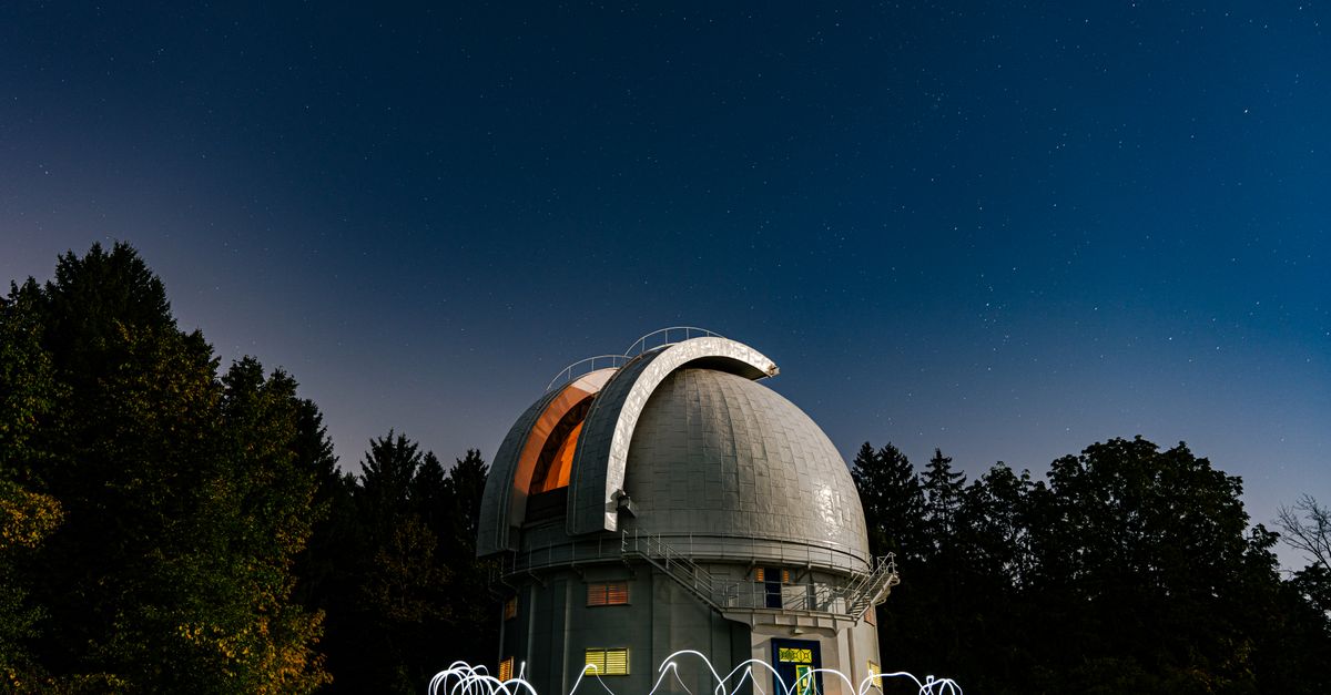 futuristic telescope array under starry night sky