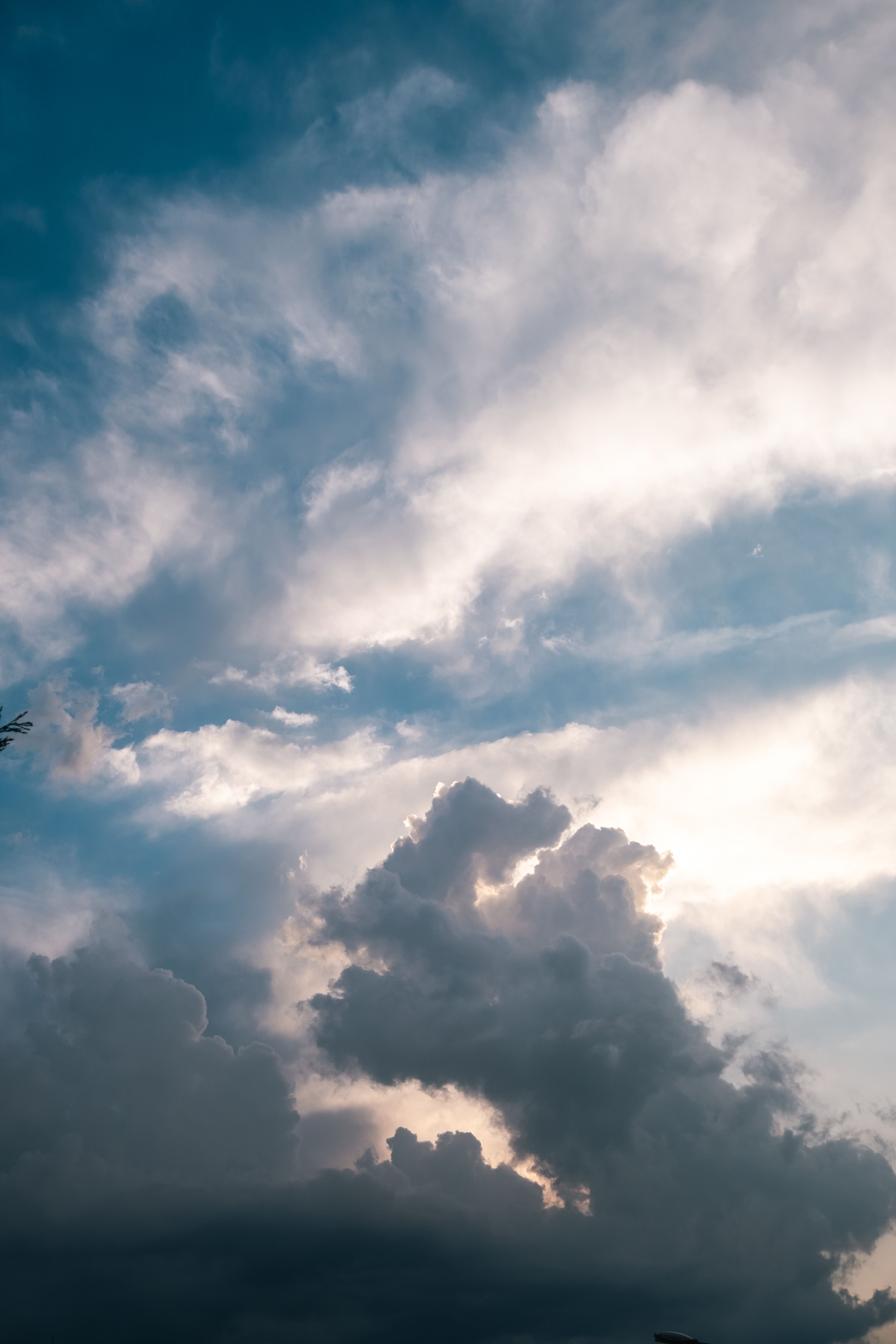 A plane flying through the clouds with a blue sky · Free Stock Photo