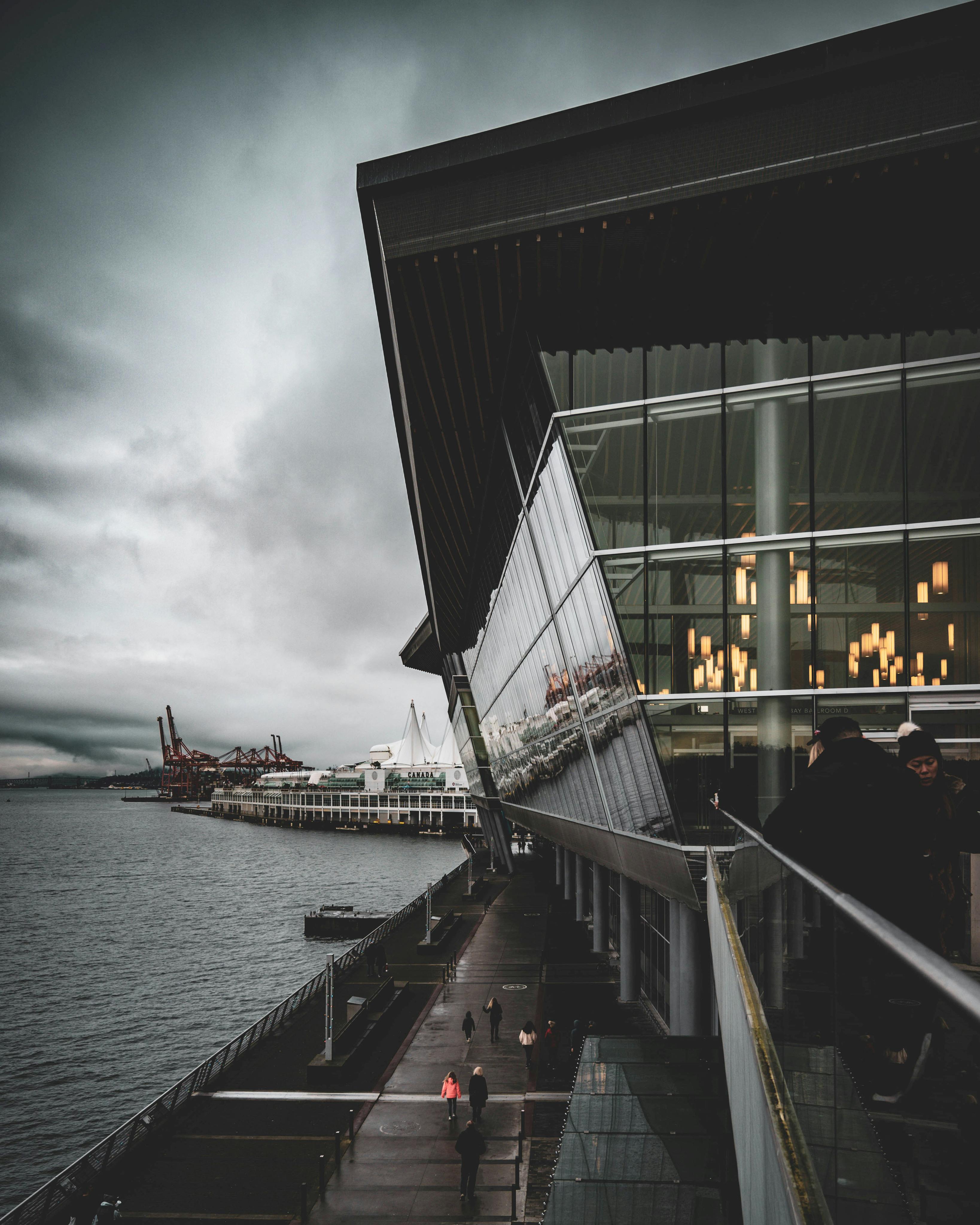 Dramatic view of Vancouver's waterfront architecture at dusk with reflections on the water.