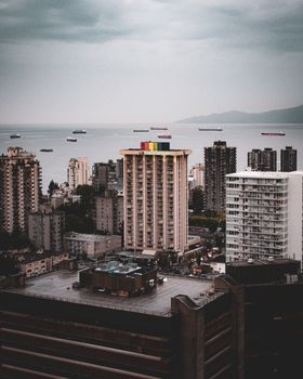 A dramatic cityscape featuring skyscrapers by the sea at dusk, ideal for urban and travel themes.
