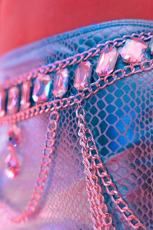 A close up of a woman's purse with chains