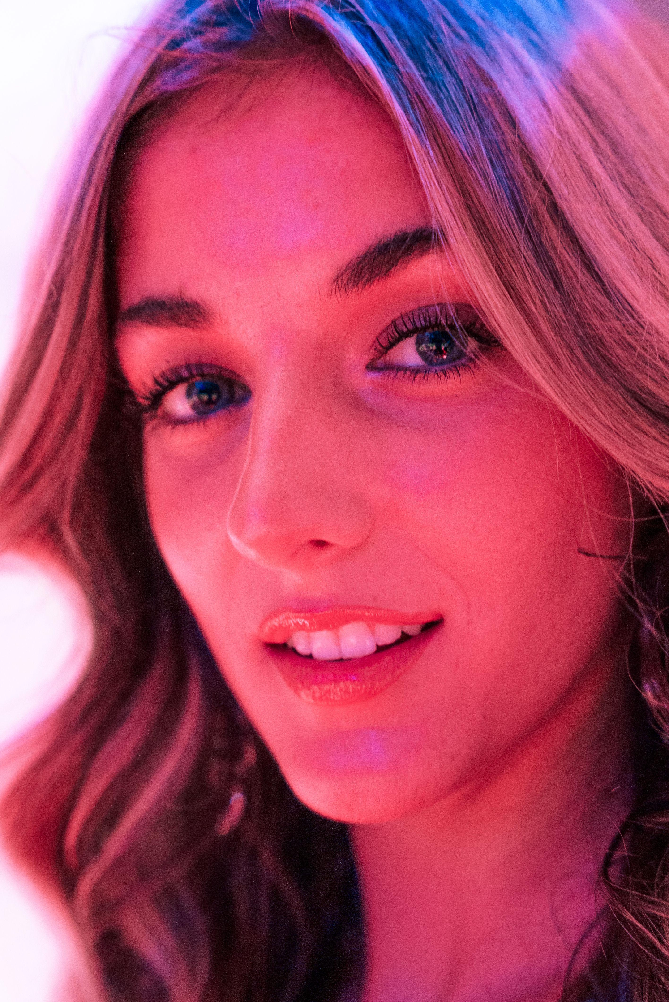 A woman with long hair and pink neon lights · Free Stock Photo