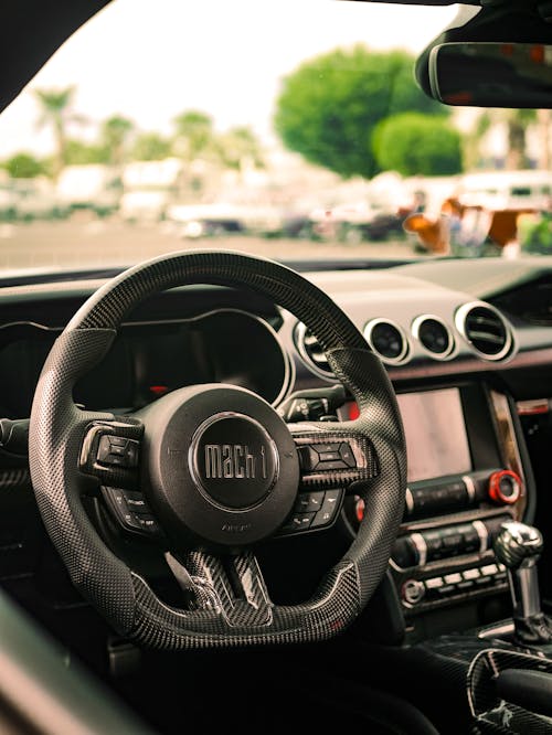 A close up of the steering wheel and dashboard of a car