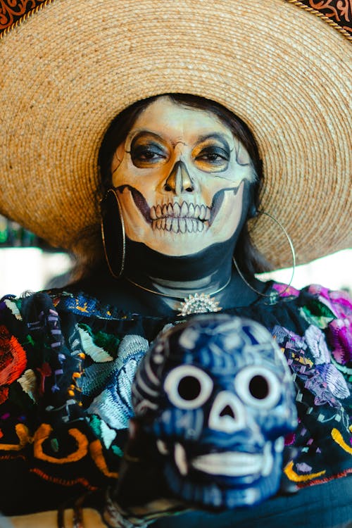 Woman with Santa Muerte Makeup in Sunhat