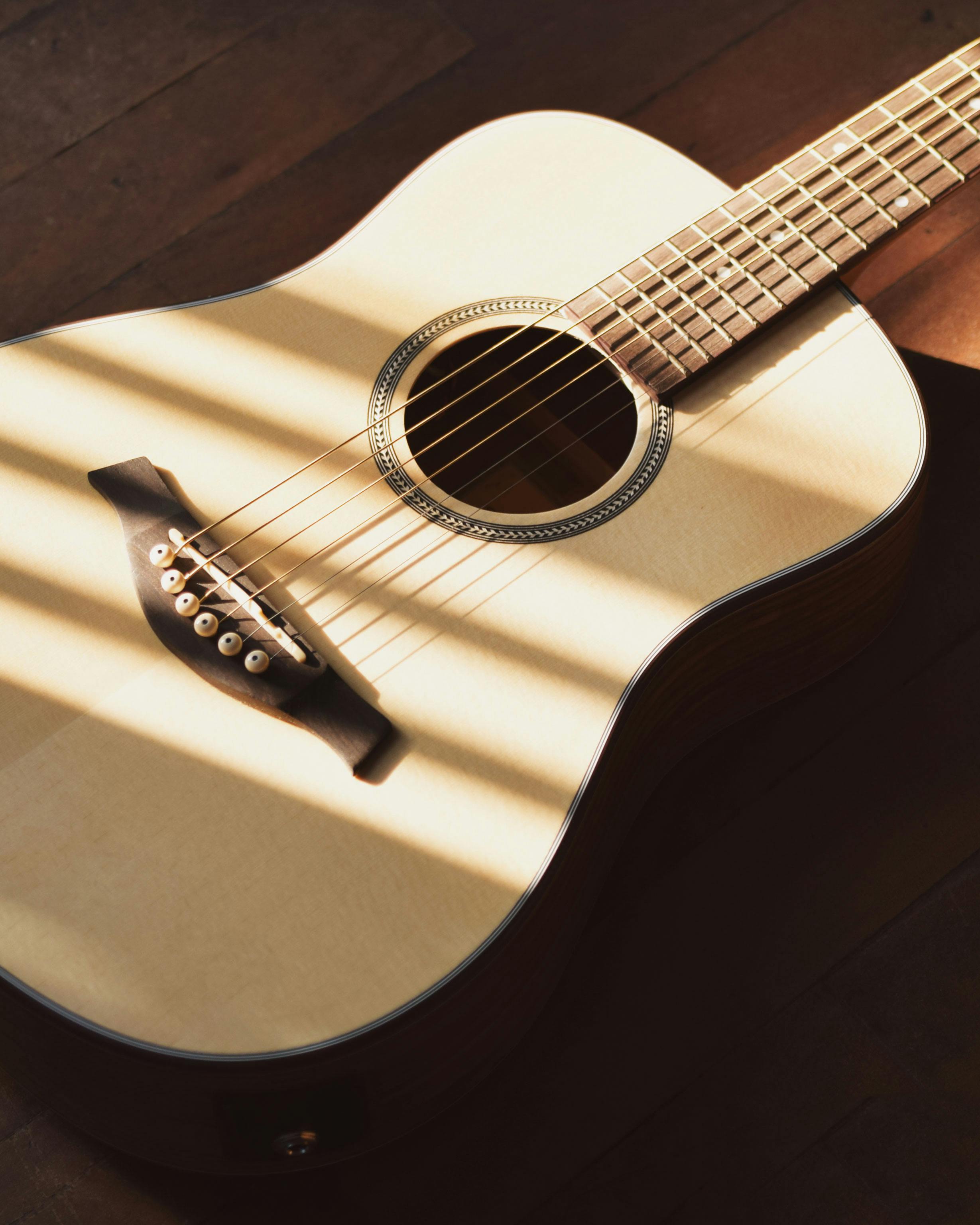 Free stock photo of acoustic guitar, acoustic guitar on a wooden surface, acoustic guitar wooden floor