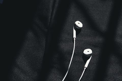 White wired earphones on dark fabric