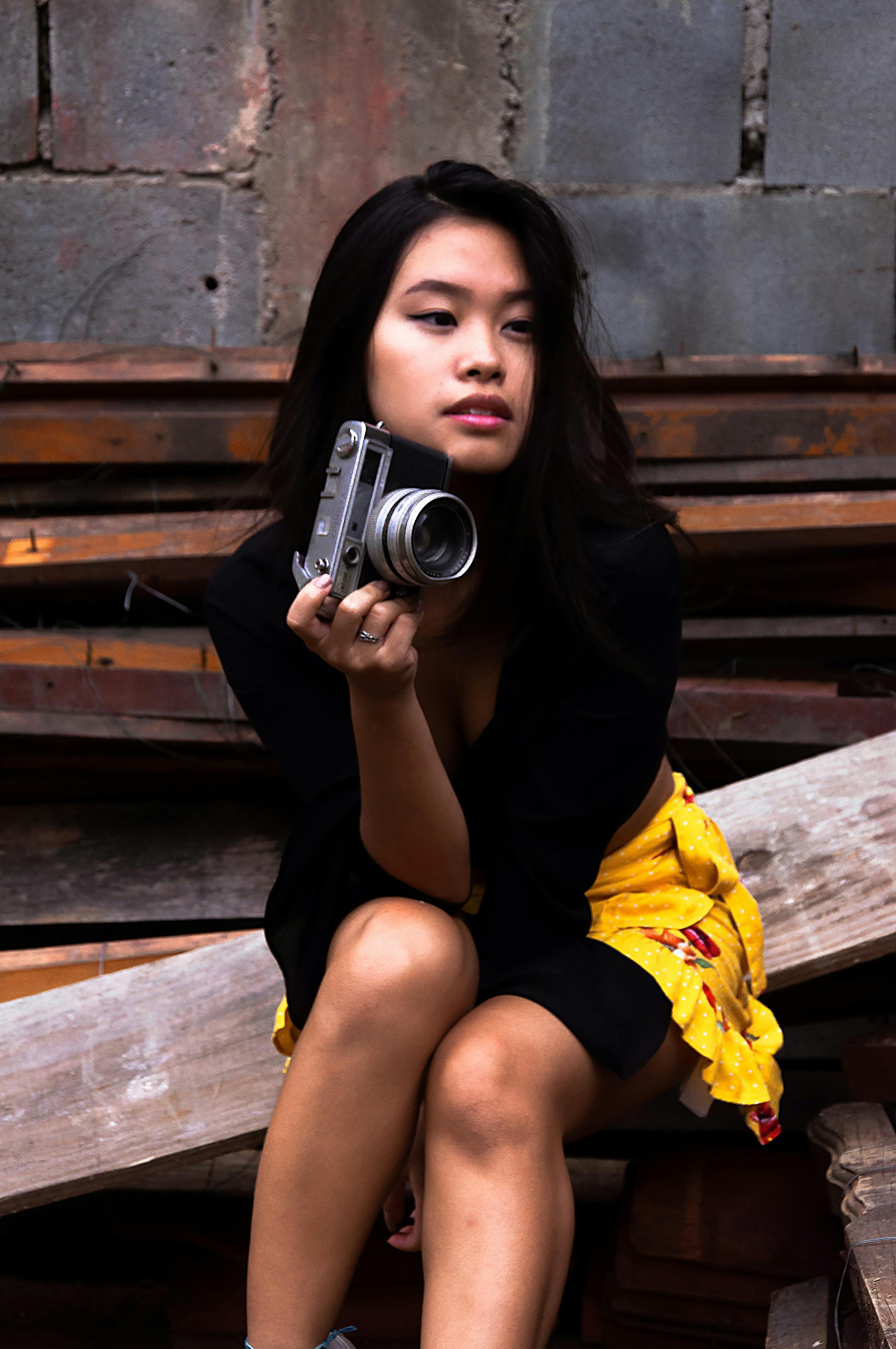 photo of woman holding camera