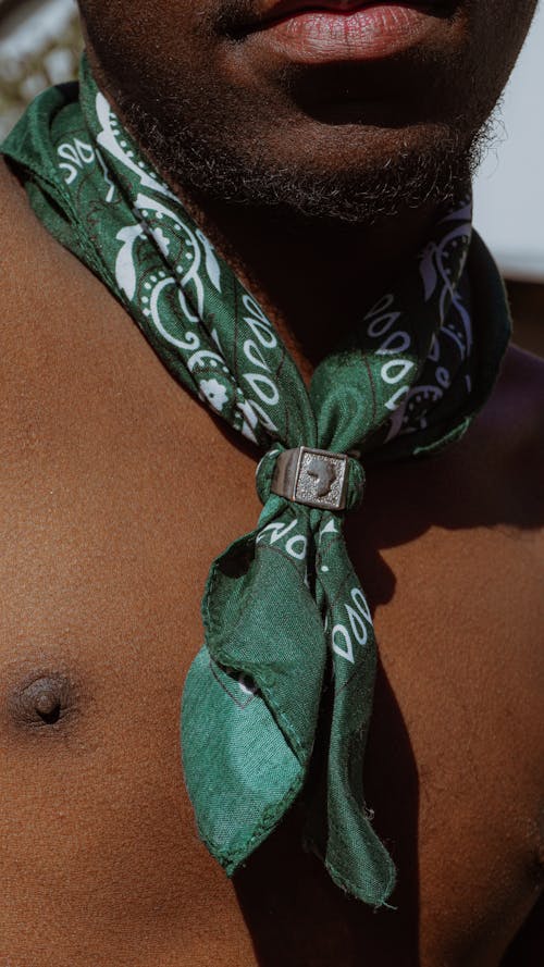 A man with a green bandana on his neck