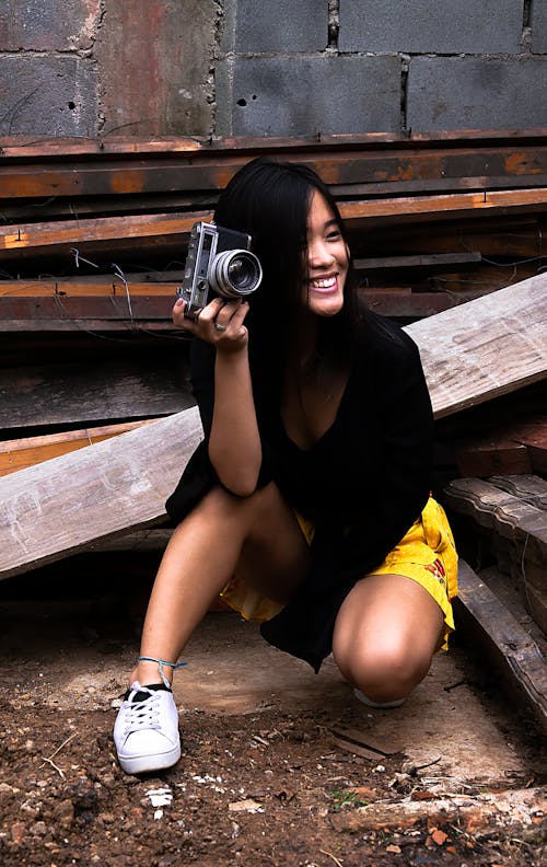 Smiling Woman Holding Camera