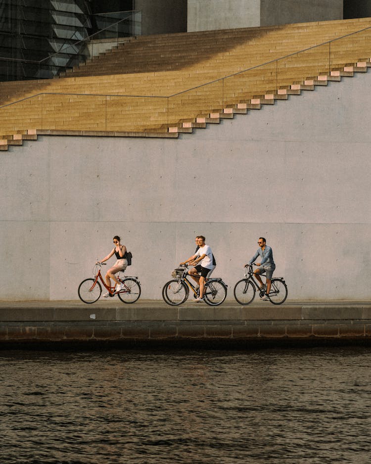 People Cycling Along The Canal 