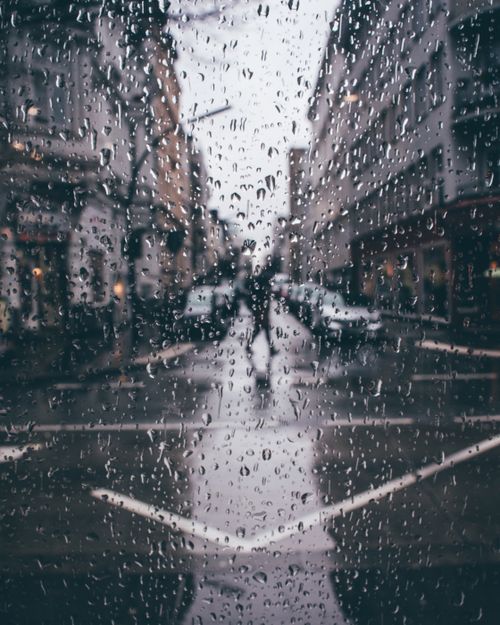 Free Blurred view through a rainy window onto a street in Hamburg, capturing the essence of a gloomy urban day. Stock Photo