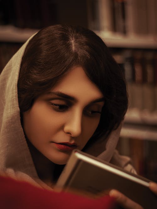 Woman with Headscarf Looking at Book