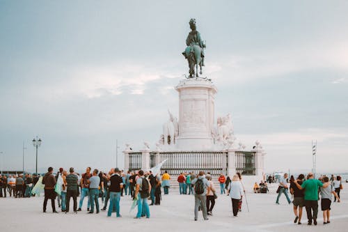 People Standing Near Statue