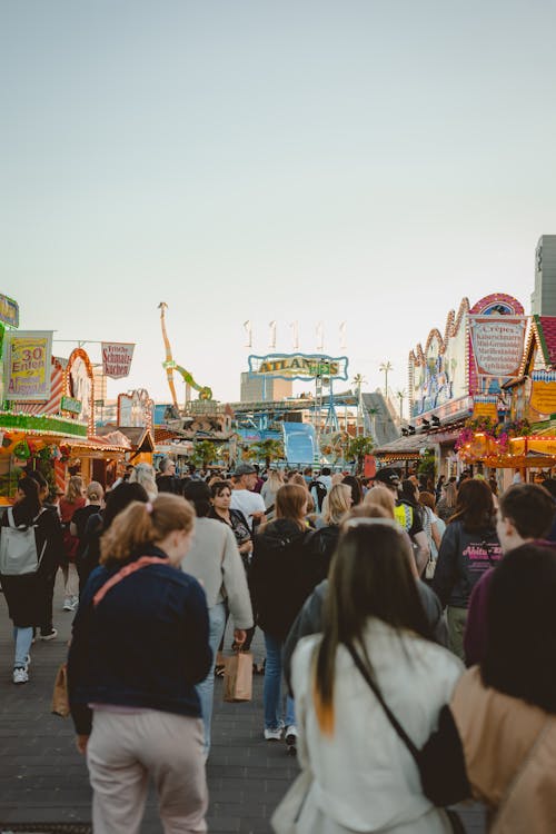 People walking through a carnival at night