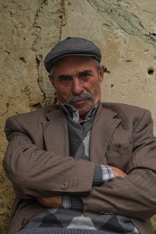 Man Wearing a Jacket and a Cap 