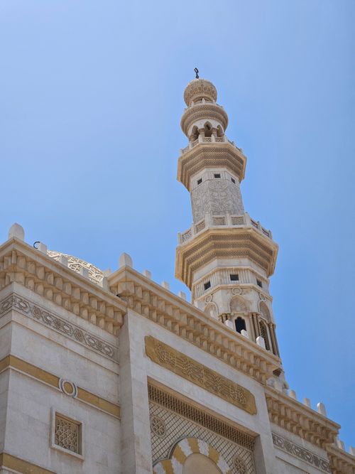 Free Stunning low-angle shot of an ornate mosque minaret in Abu Dhabi, capturing intricate religious architecture. Stock Photo