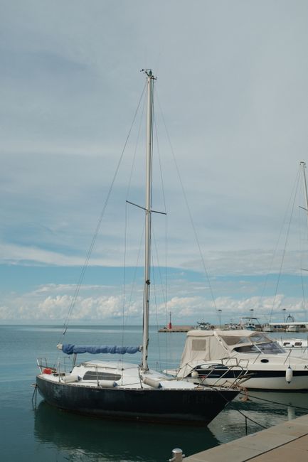 Peaceful view of sailboats moored in Koper marina on a serene day, Slovenia.