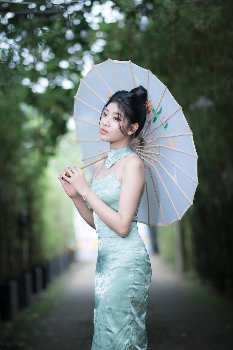 Model In Satin Dress Holding Umbrella