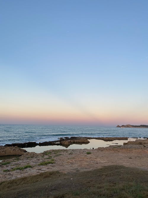 View of Beach and Sea at Sunset 