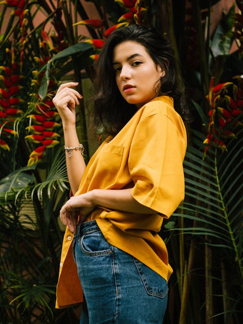 Free Woman Standing Near Birds of Paradise Flower Stock Photo