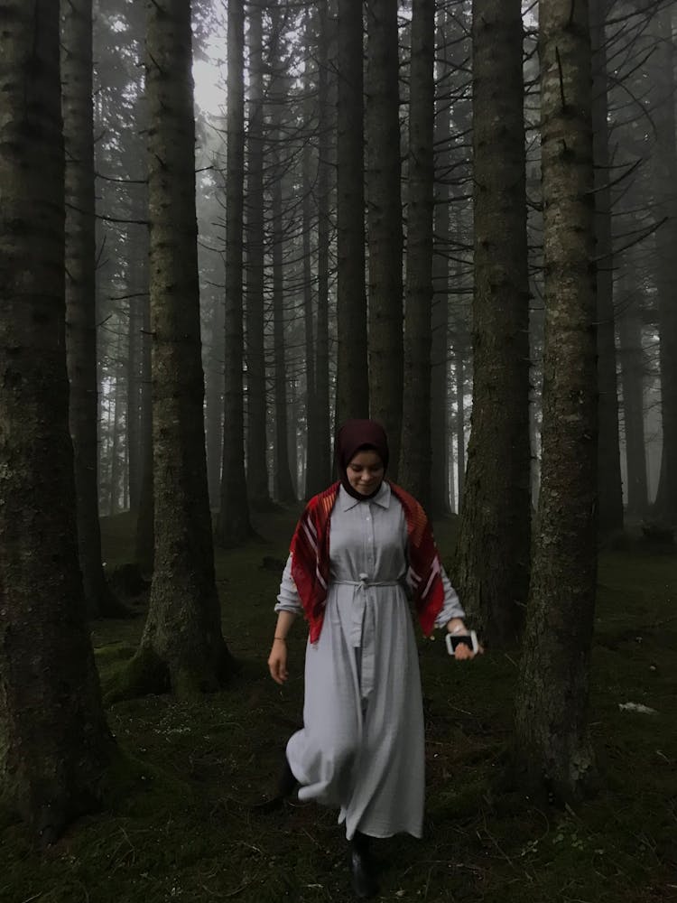 Woman In Hijab Walking In Deep Forest