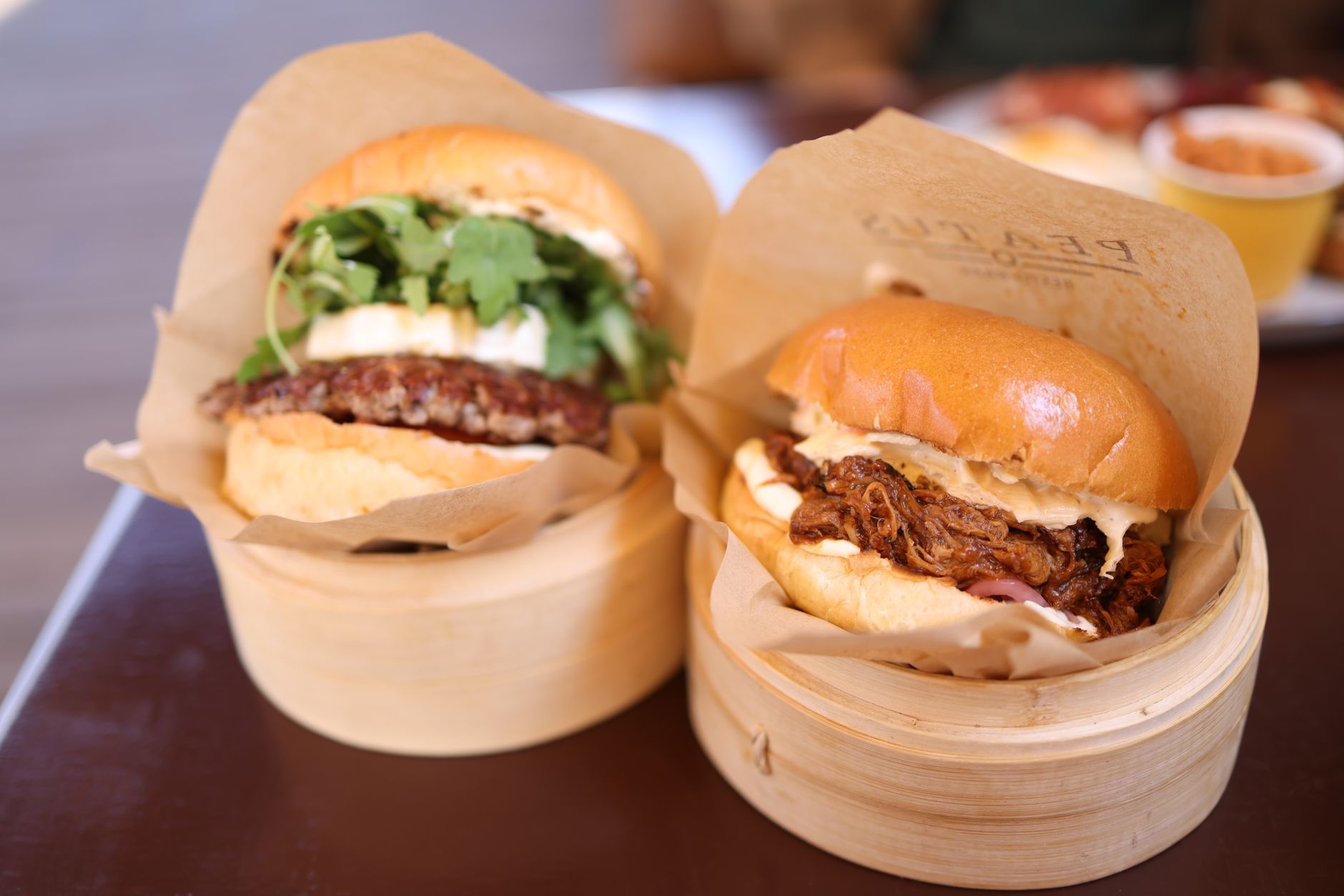 18 Mouthwatering Burger Recipes for Everyone Close-up of gourmet beef burgers served in bamboo steamers, perfect for food photography.