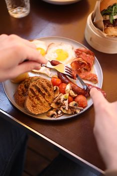Savor a classic English breakfast with eggs, toast, and sausages for a hearty start to the day.