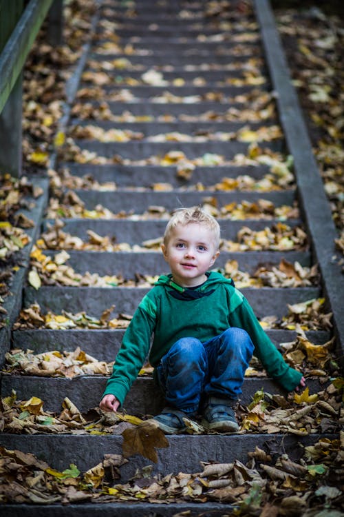 Boy Sitting On Stairs