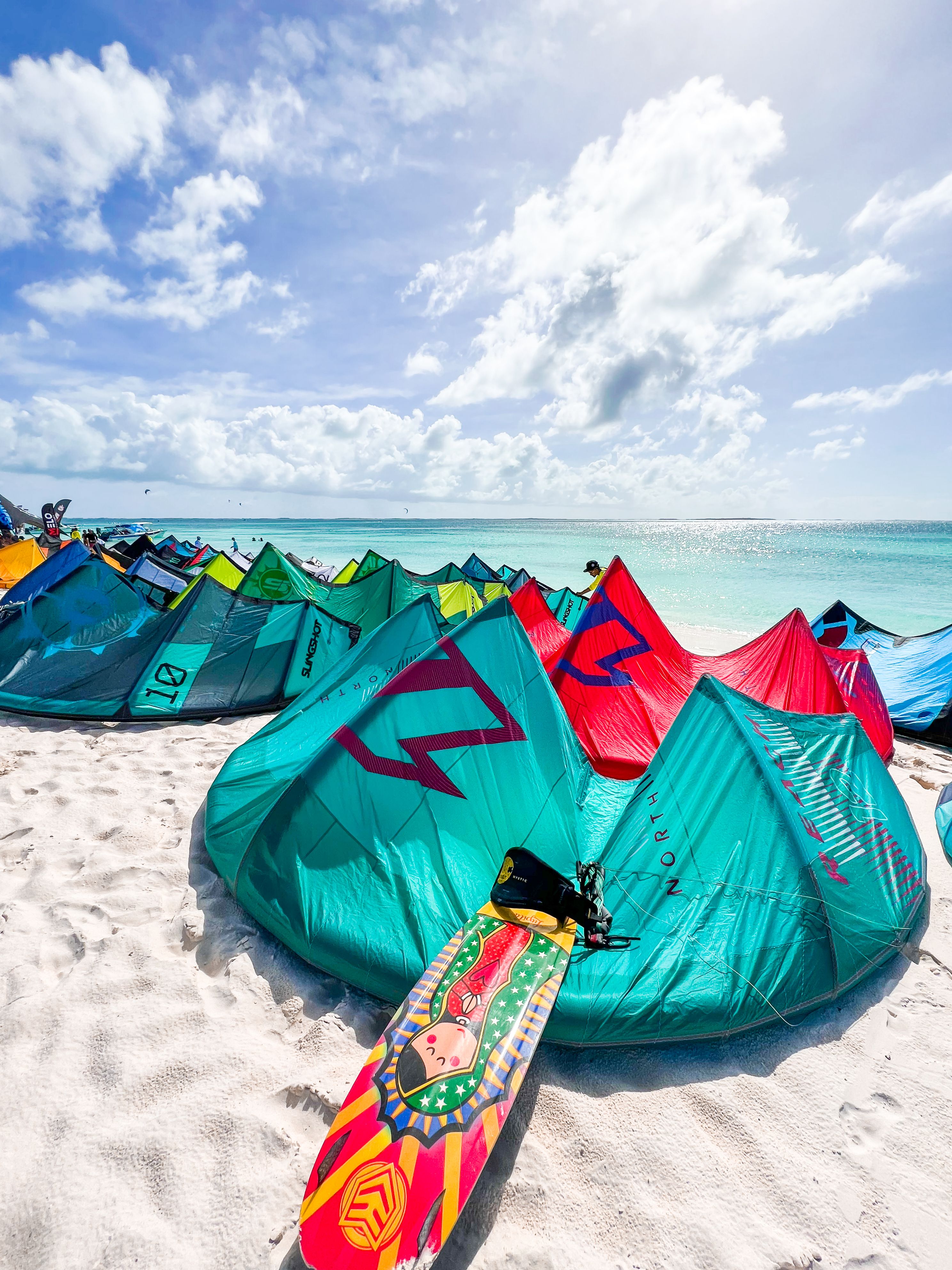 A group of colorful kites on the beach · Free Stock Photo