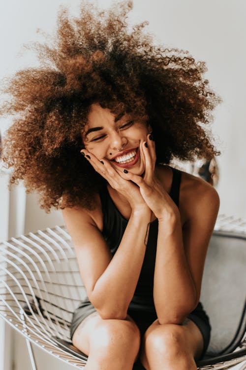 Free Woman Sitting And Smiling Stock Photo