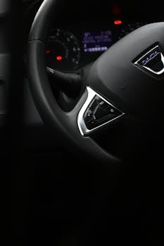 Detailed view of a Dacia car steering wheel, showcasing interior design and logo.